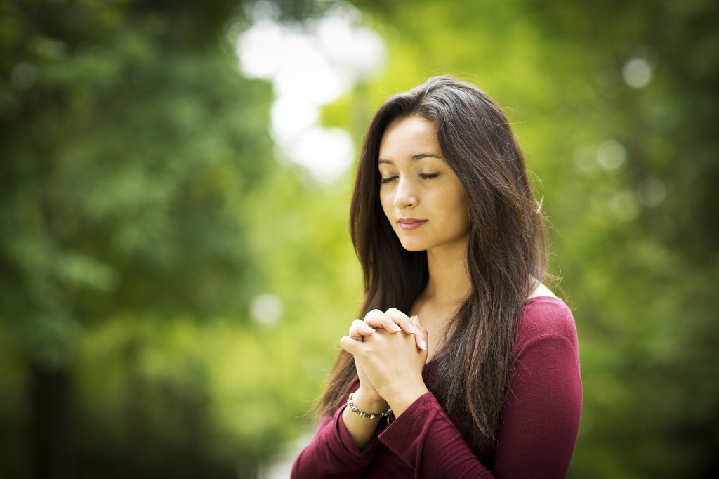 Woman praying outdoors