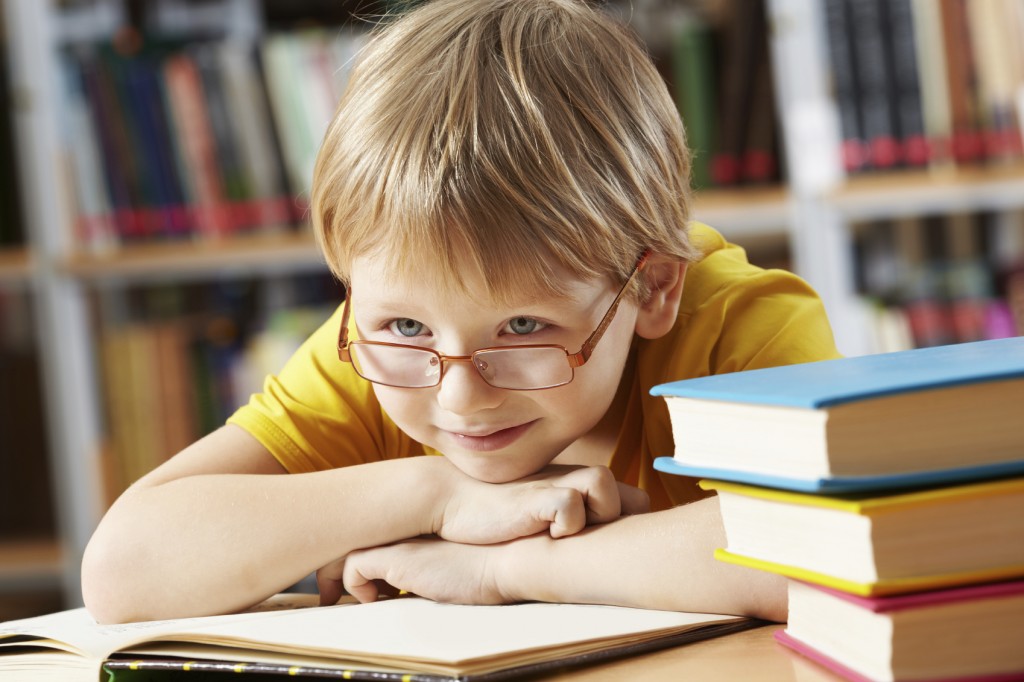 boy with open book in library