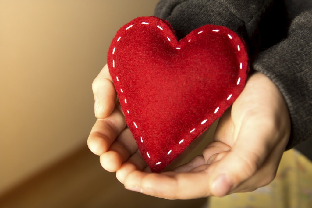 Red heart in child hands, gift