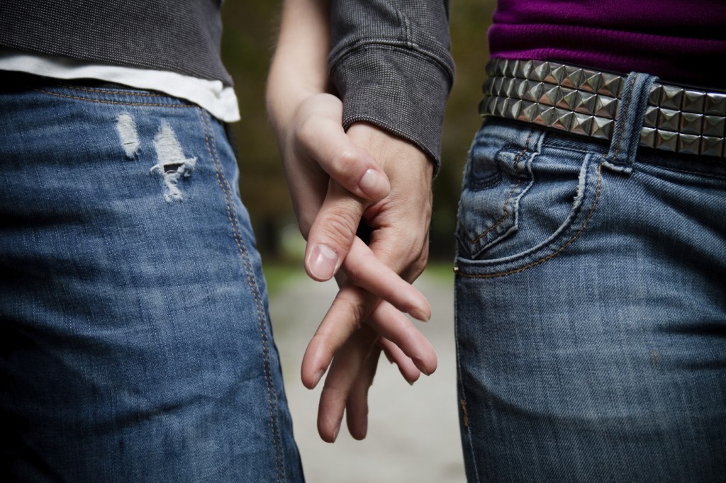 Detailed view of young couple holding hands