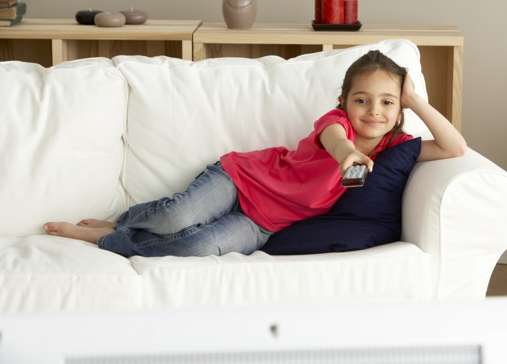 Young Girl Watching Television at Home