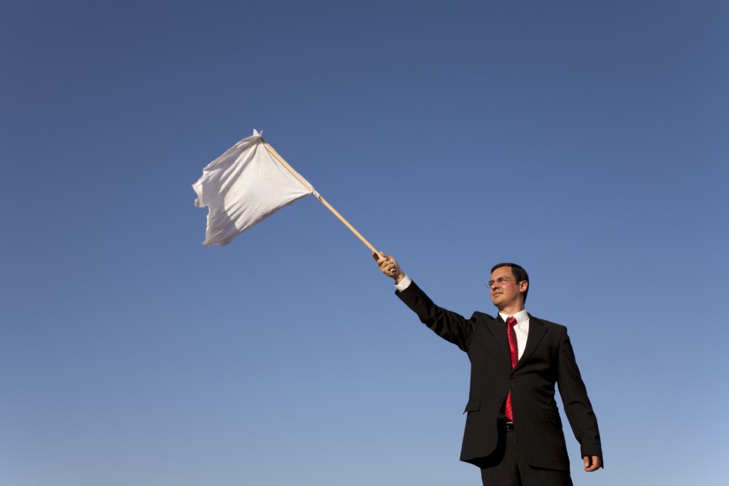 businessman asking for surrending with a white flag