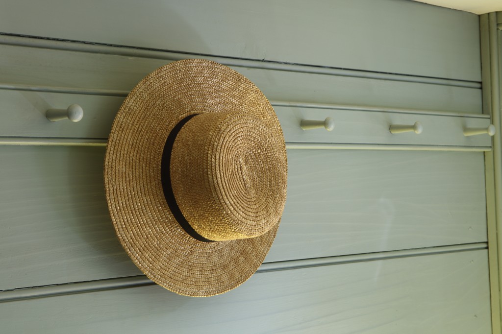 Straw hat hanging on a peg