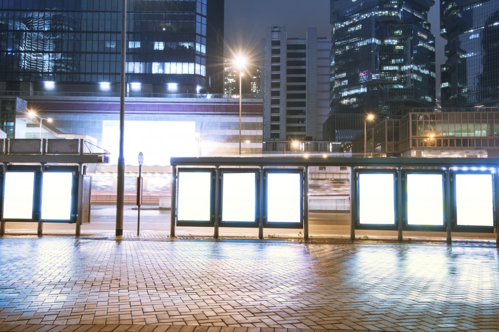 Billboards, bus station, city at night