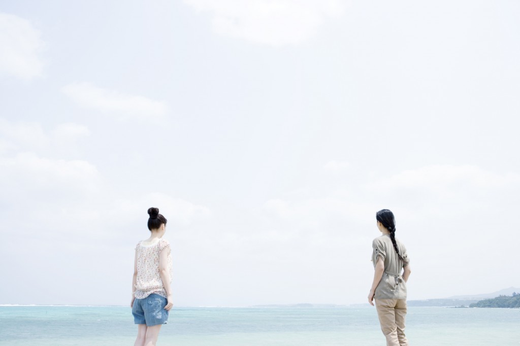 Mother and daughter standing on beach