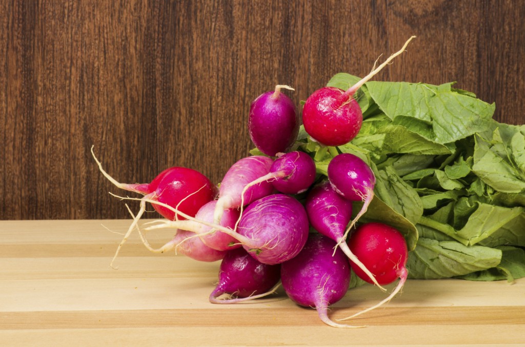Bunch of colored red and pink radishes in the kitchen