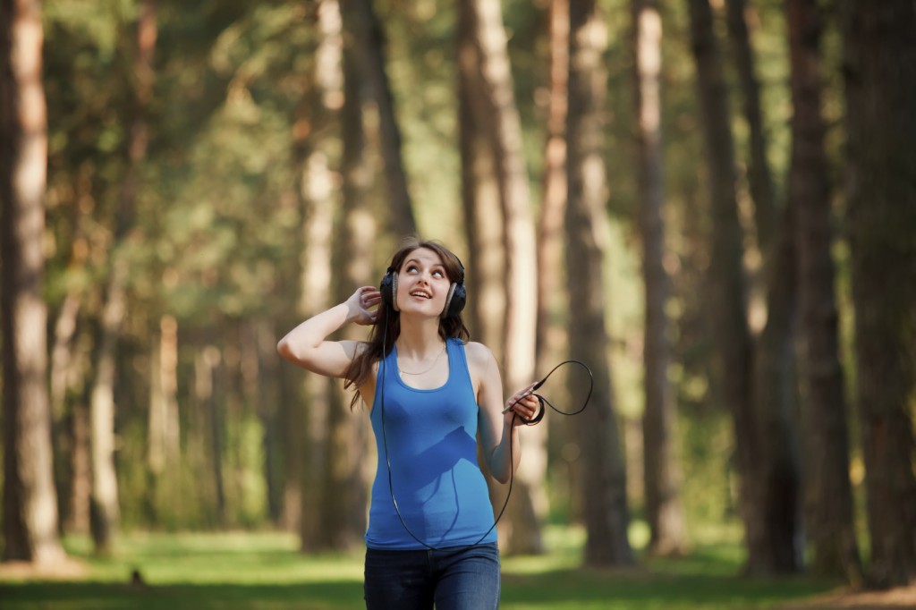 Girl walking in a park and listening music