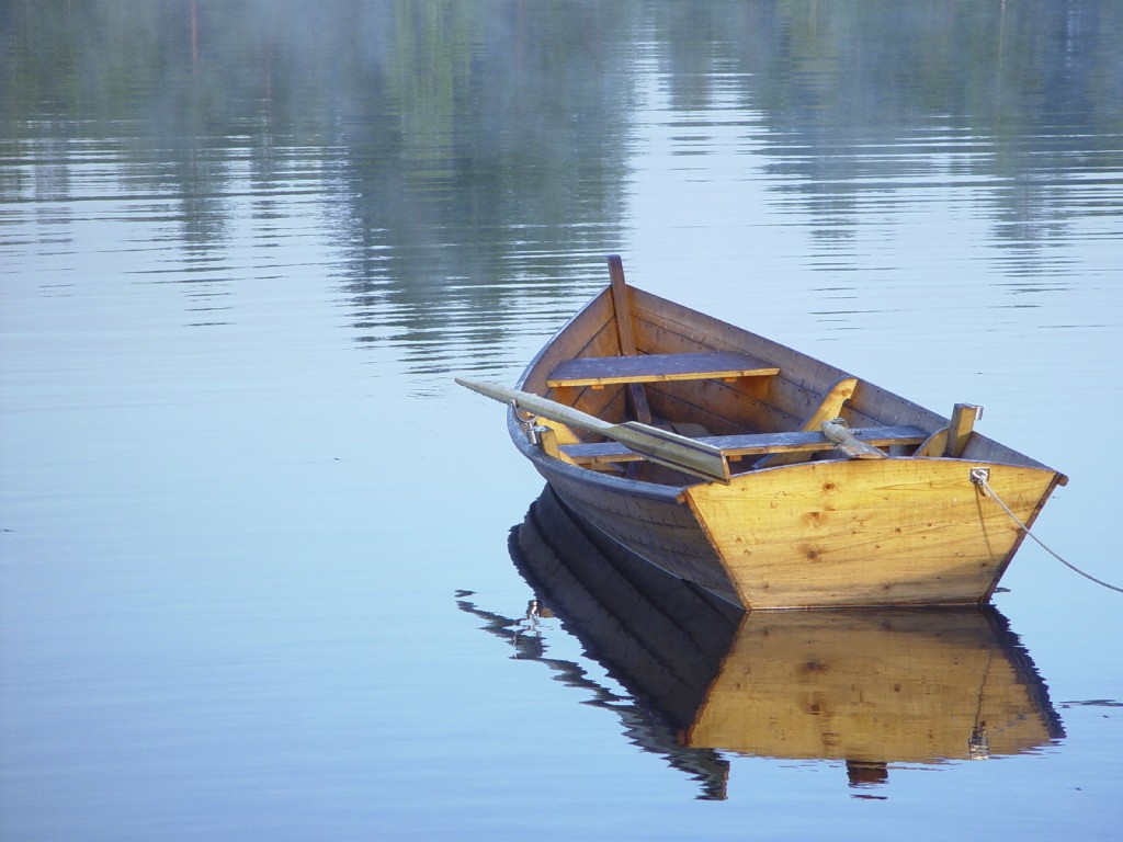 small boat sitting on calm water