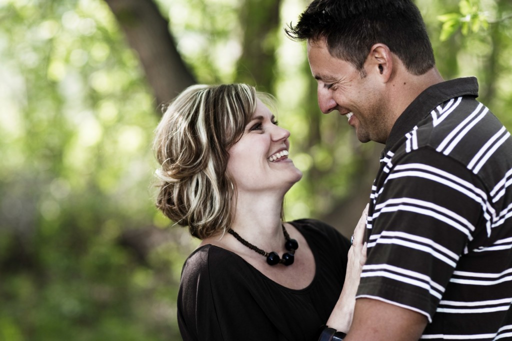 middle aged couple looking up at each other and smiling.