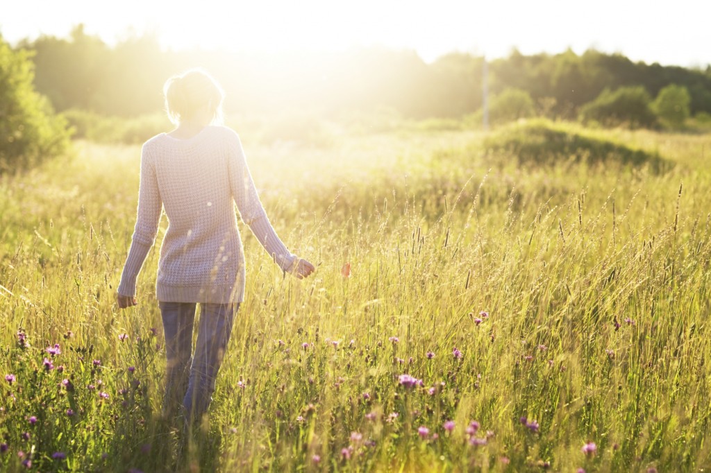 Woman walking without fear through a sunlight field