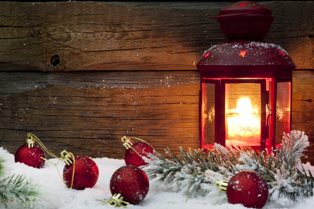 lantern and Christmas decorations set in snow.