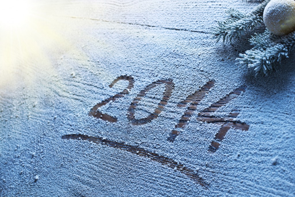 New Year 2014 on snow-covered wooden desk.