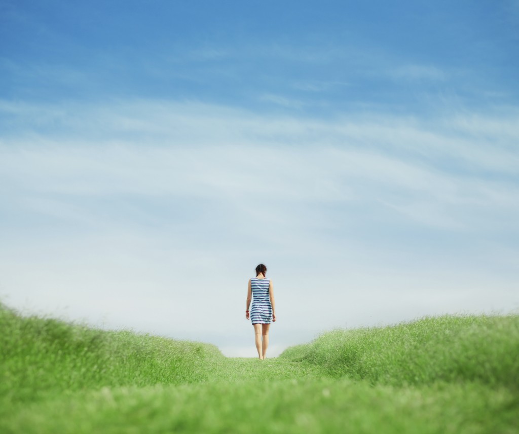 Young girl walking on grass field