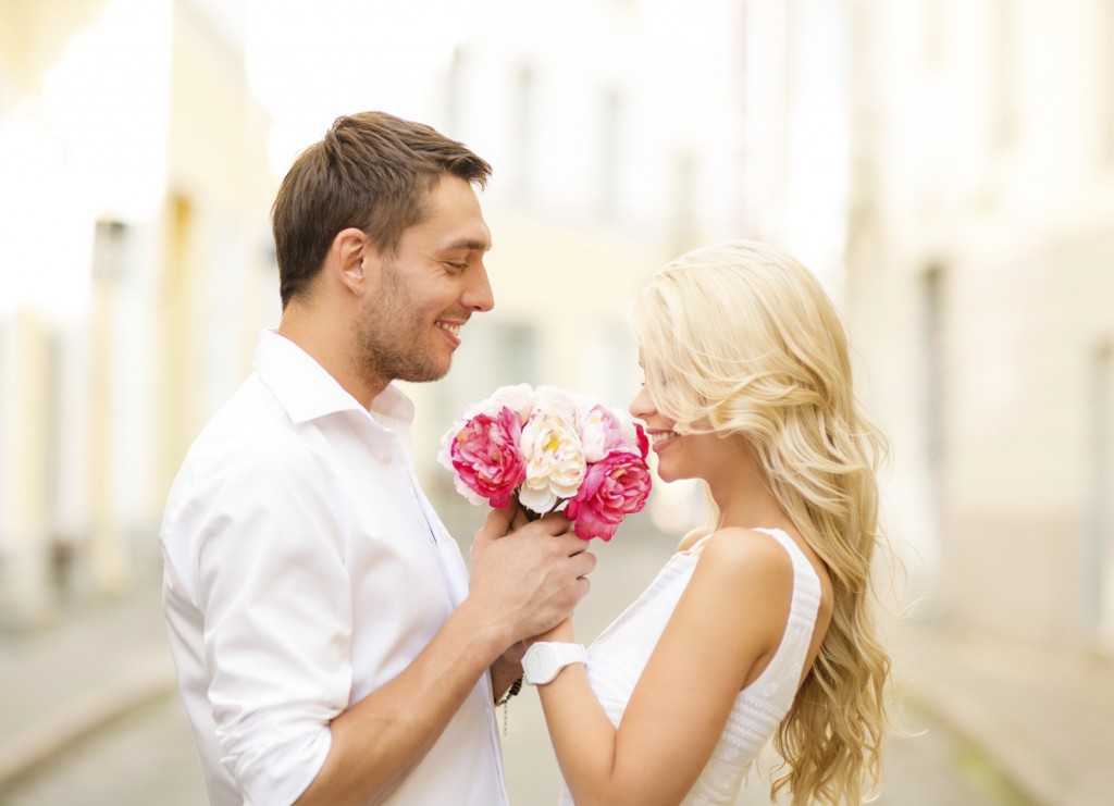 couple with bouquet of flowers in the city