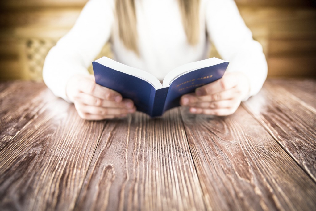 The girl reads the Bible