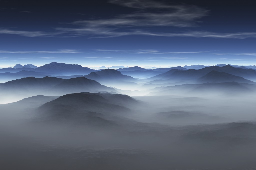 Aerial view of misty mountains, early morning.