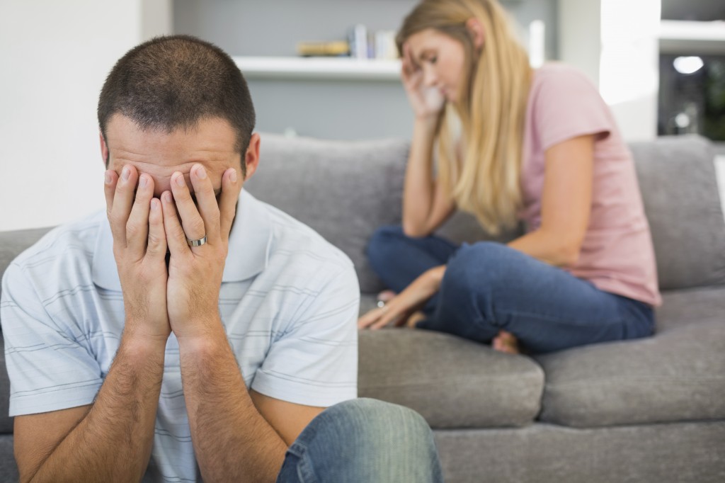 Couple having difficulties in sitting room at home