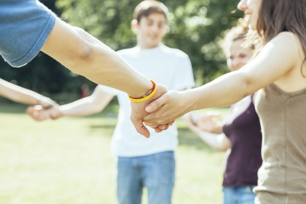 Group of friends holding hands in a circle