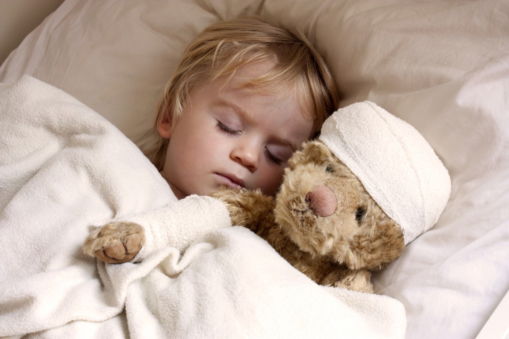 boy and teddybear in bed