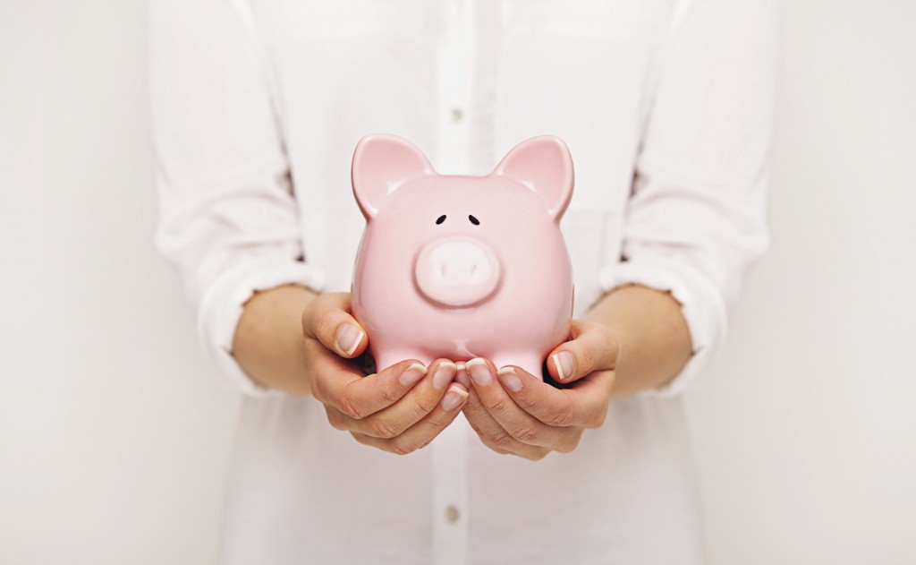 Close-up of a Piggy Bank in the Hands of a Woman