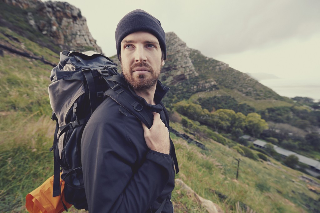 Potrait of adventure trekking man in mountains with backpack