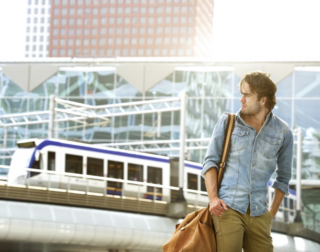 young man traveling with bag