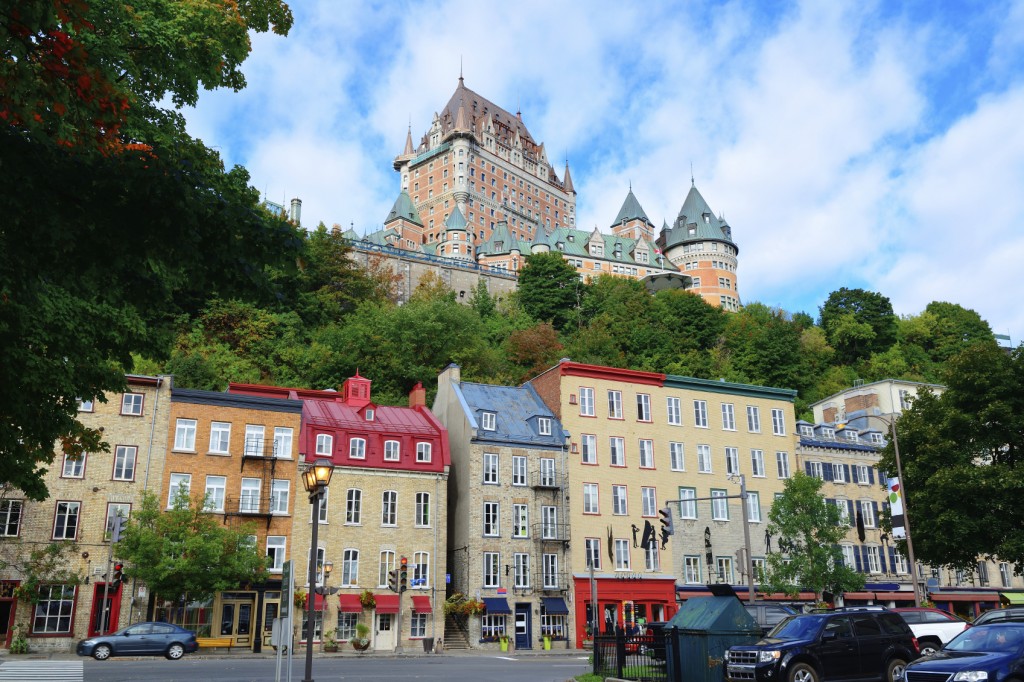 Chateau Frontenac in the day with colorful buildings on street in Quebec City