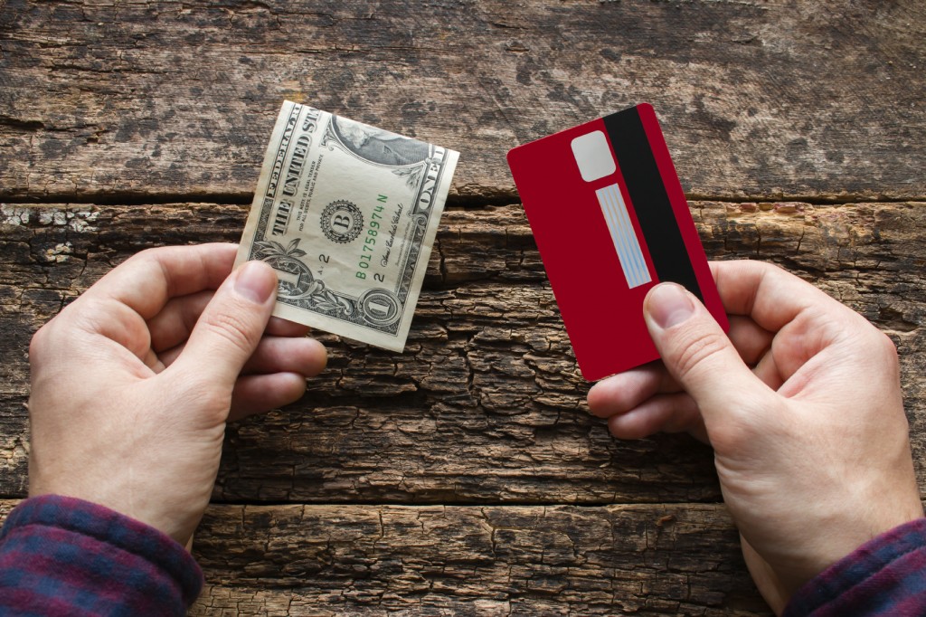 man holding credit card and money