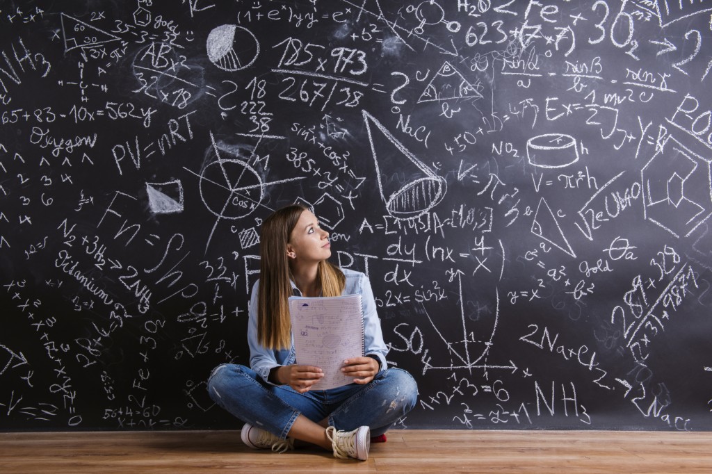 Student in front of blackboard