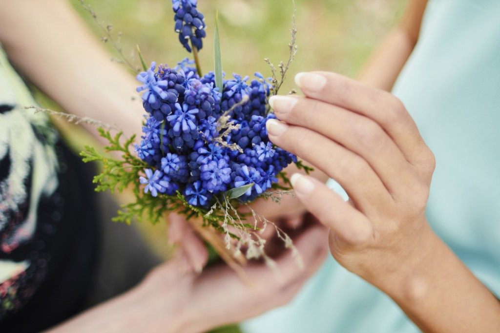 Lovers hands holding a bouquet of flowers