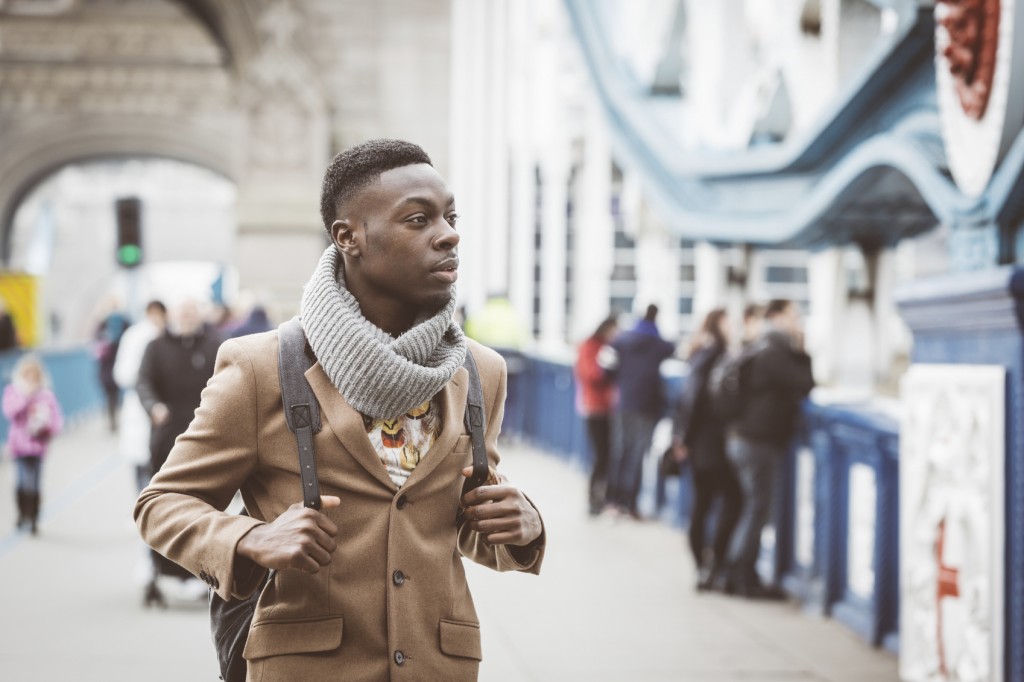 Young black man in London walking on Tower Bridge