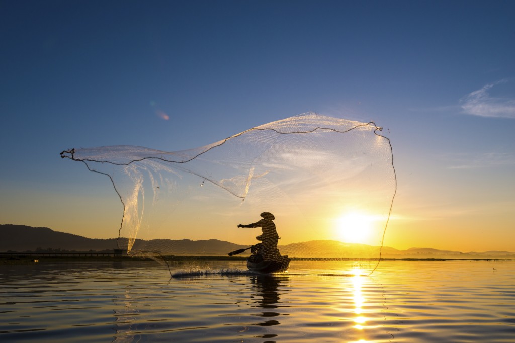 Fisherman in action during fishing in morning