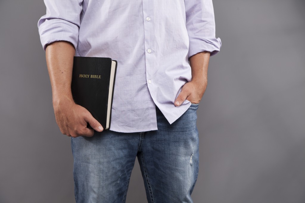 Man Casually Holds Bible