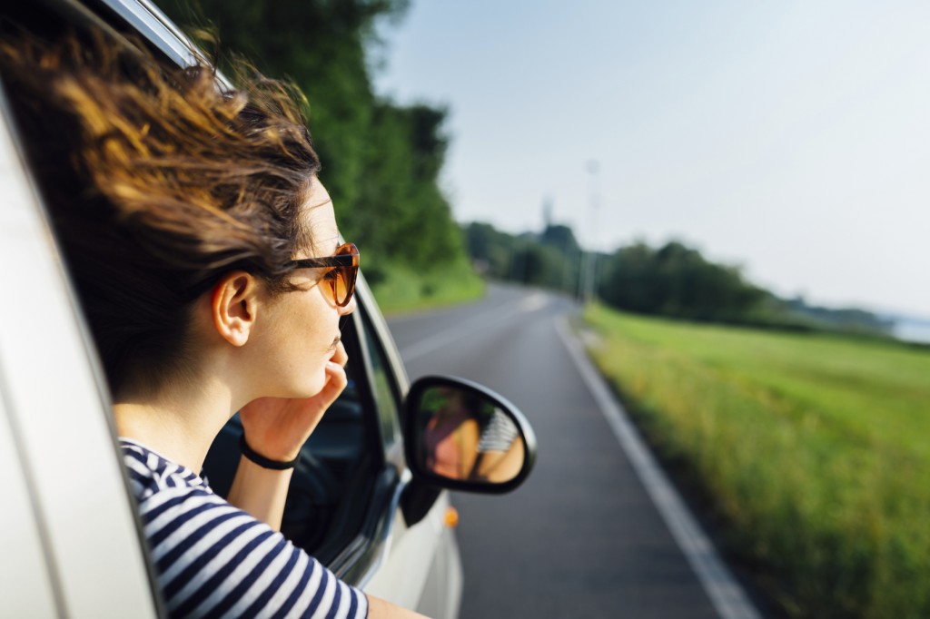 Wanderlust woman look at view traveling by car