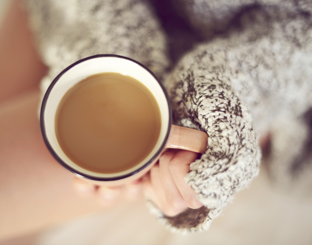 woman's hands holding a cup of coffee close-up