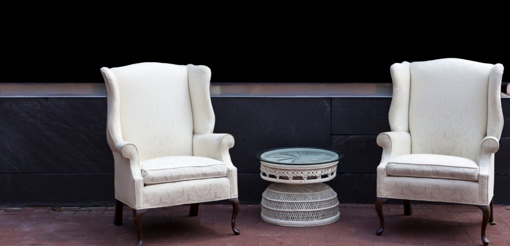 Two wing chairs outdoors on brick patio