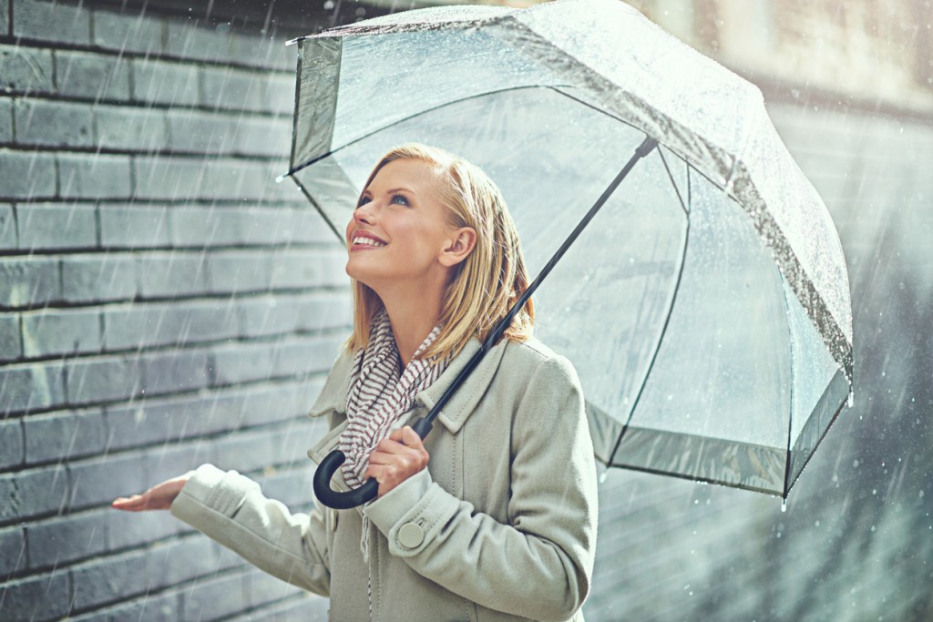 Cropped shot of an attractive young woman walking in the rain