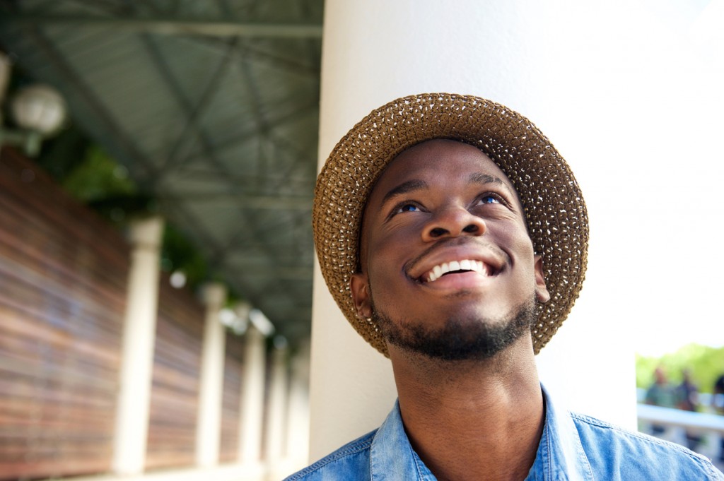 Close up portrait of a happy young man smiling and looking up