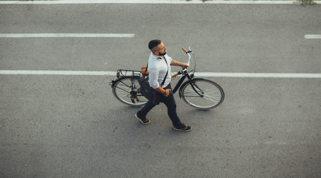 Businessman Pushing Bicycle and going home late.