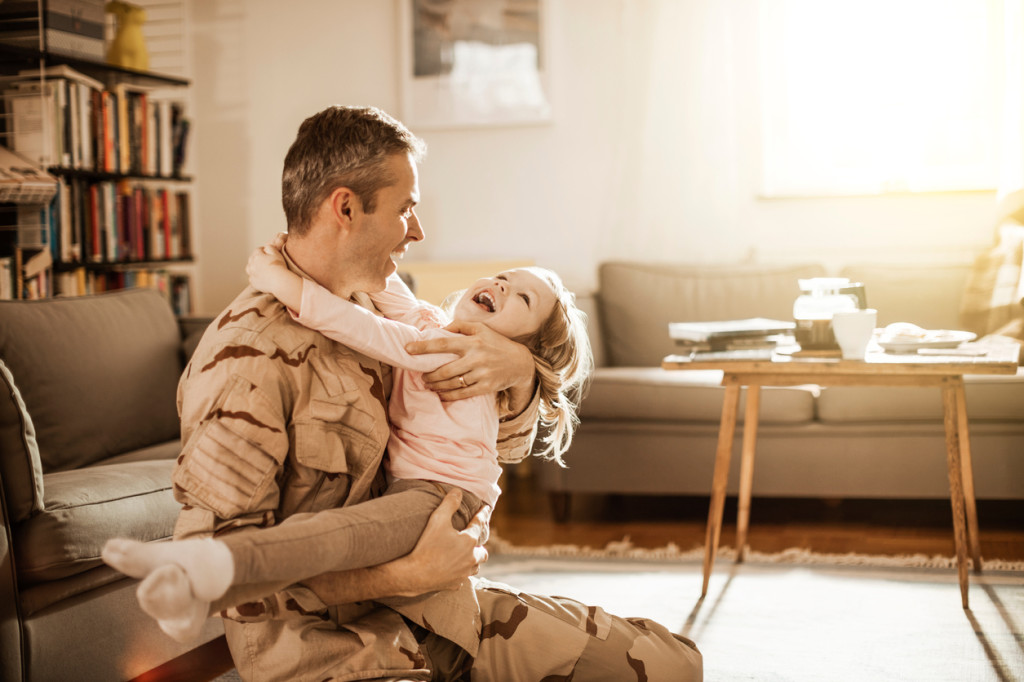American soldier playing with his daughter