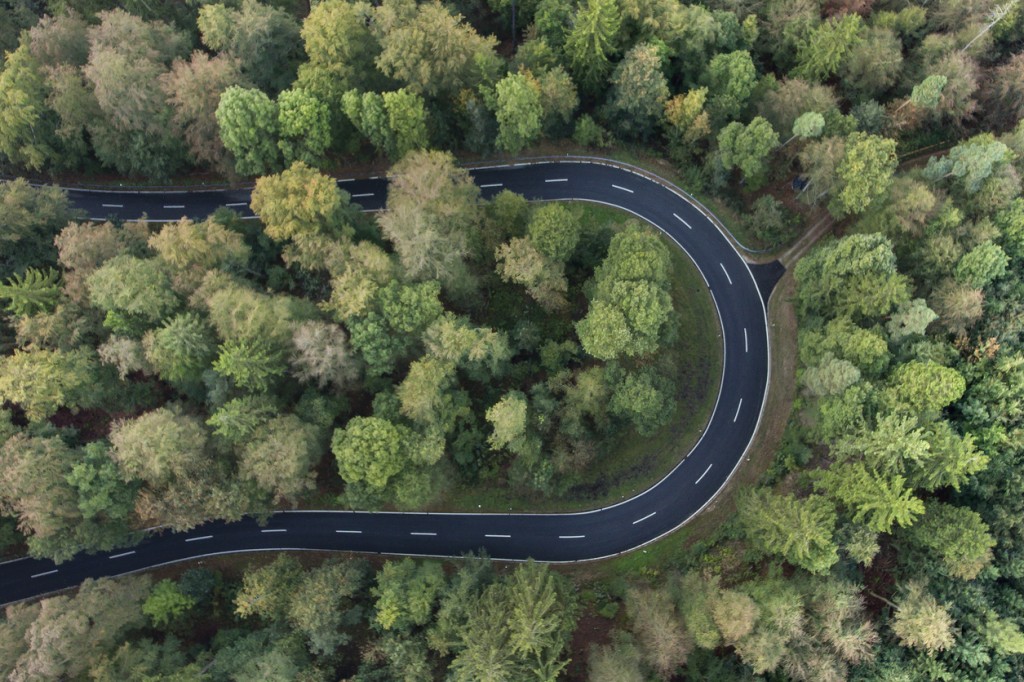 Road curve in the forest aerial view