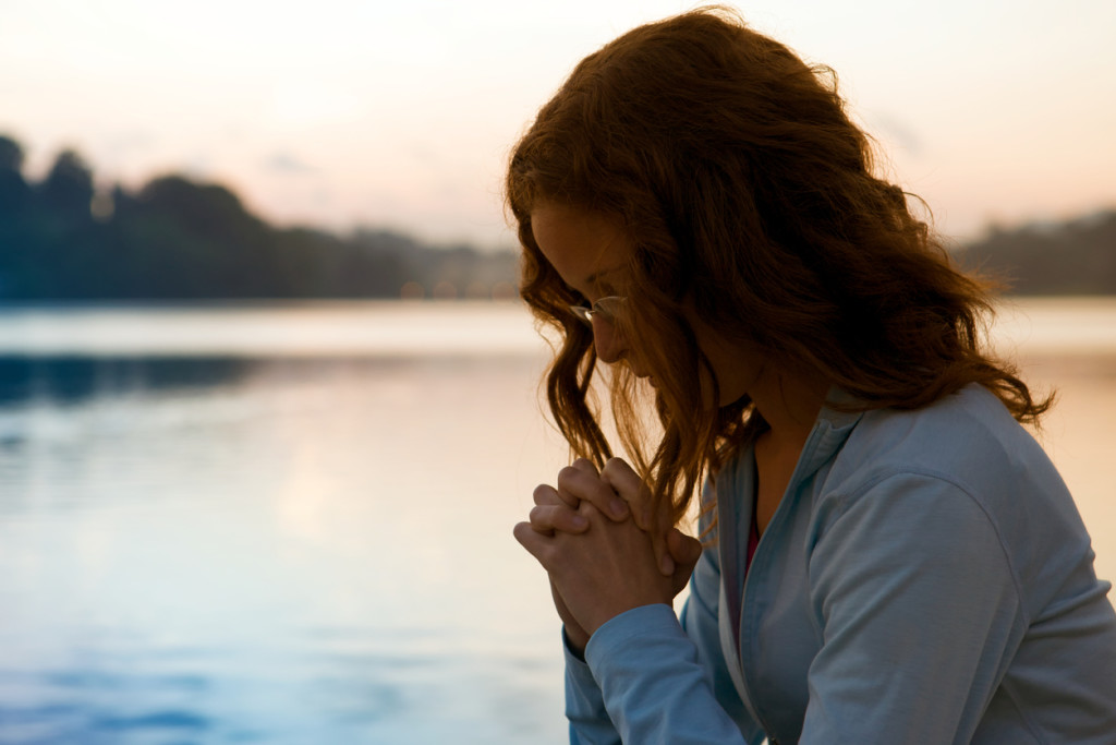 Woman In Prayer At Sunrise
