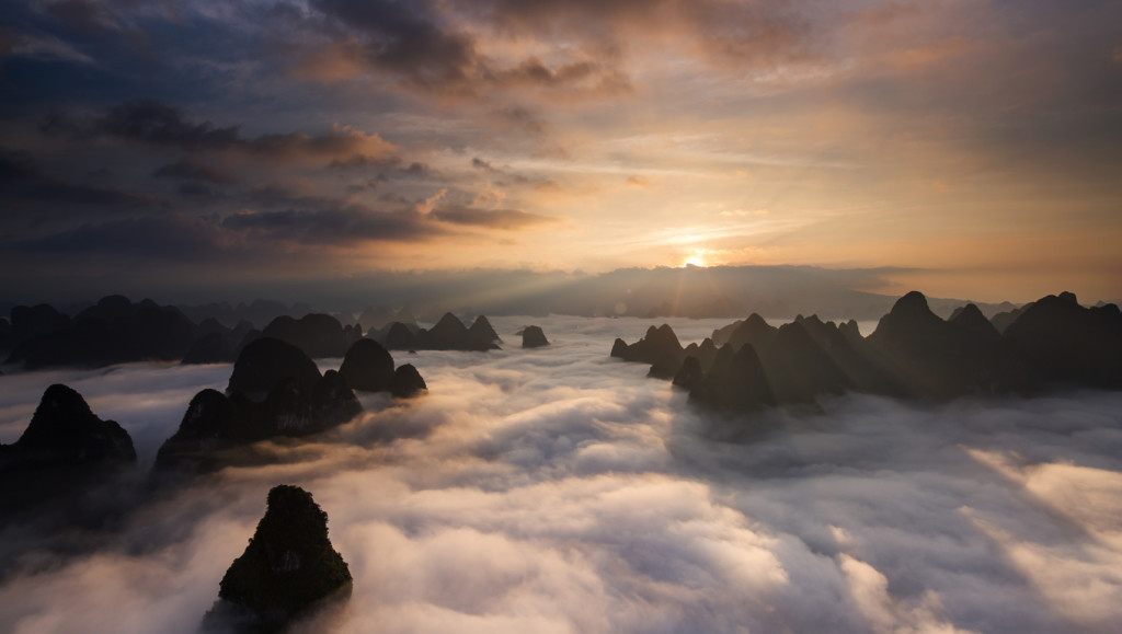 Sunrise over the clouds with karst formation mountains in Guilin, China