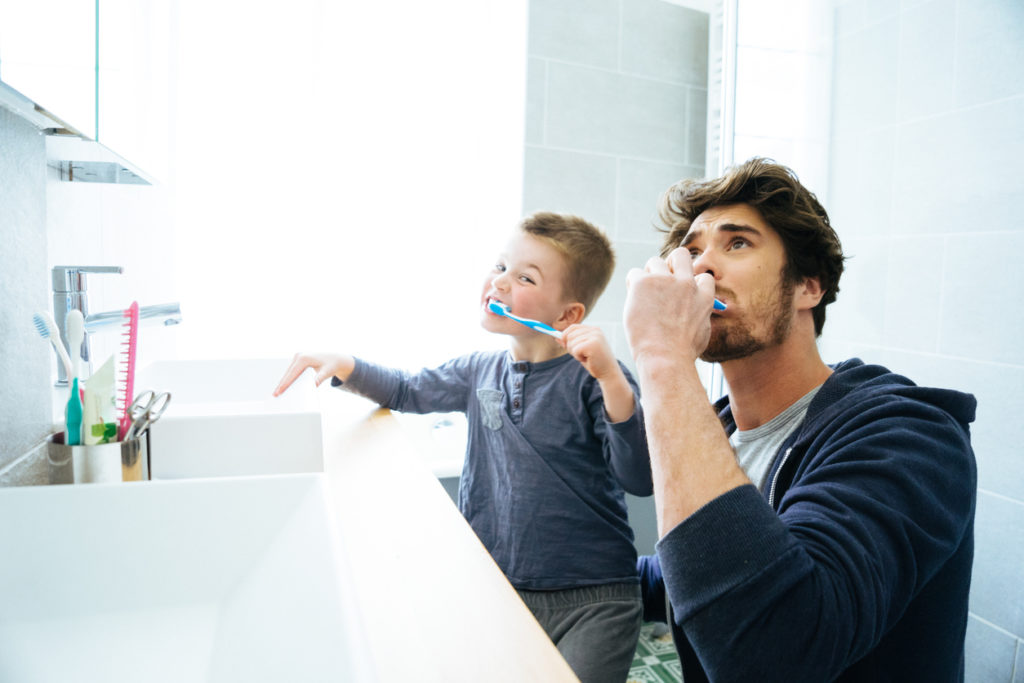 Father And Son Brushing Their Teeth