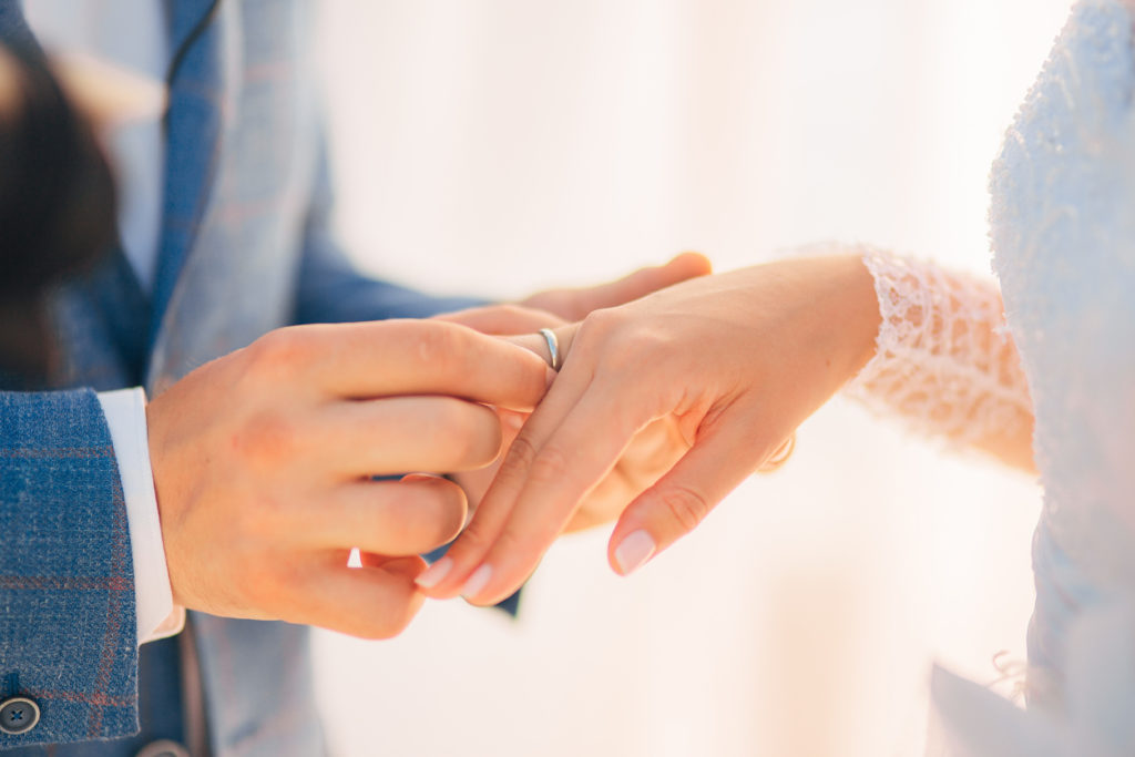 The newlyweds exchange rings at a wedding