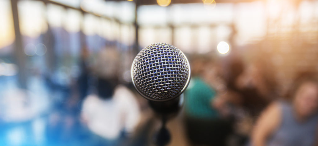 Microphone infront of an out of focus audience