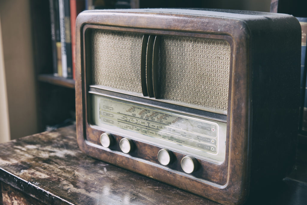 Obsolete radio in wooden case. Horizontal indoors shot