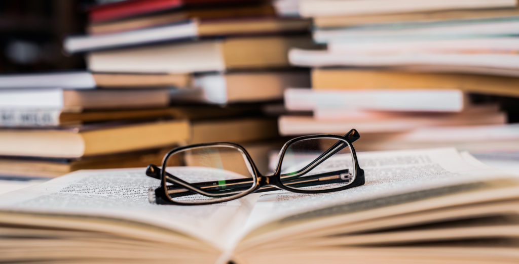 Reading glasses on a book. Close-up