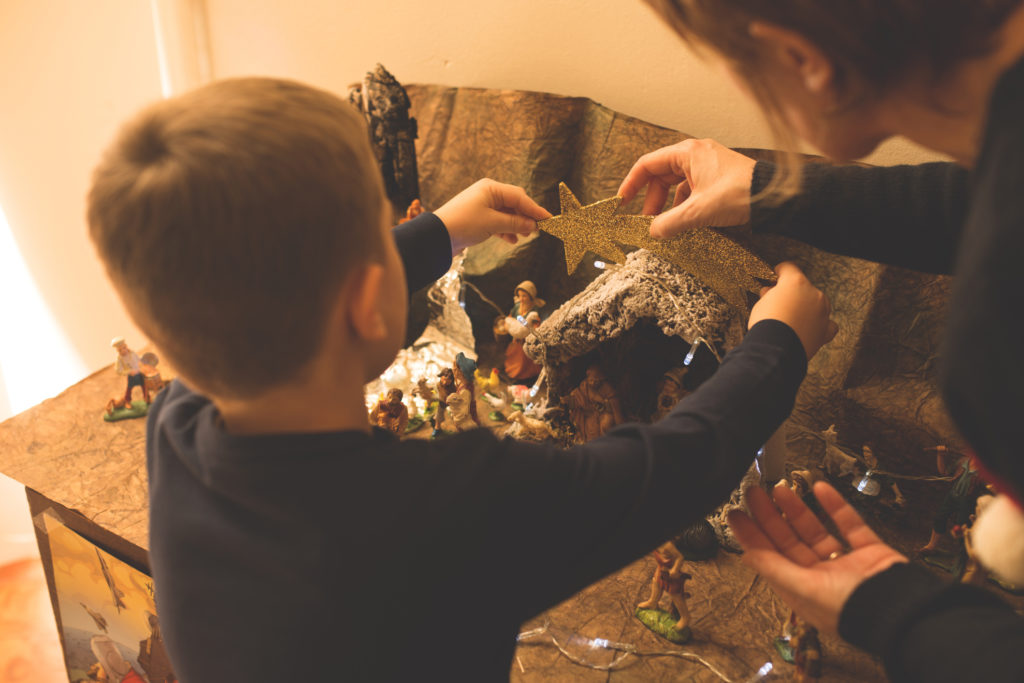 Christmas - Mother and son making nativity scene