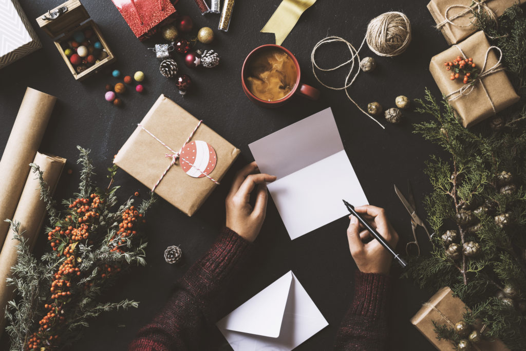 Writing New Year Christmas cards, table top flat lay